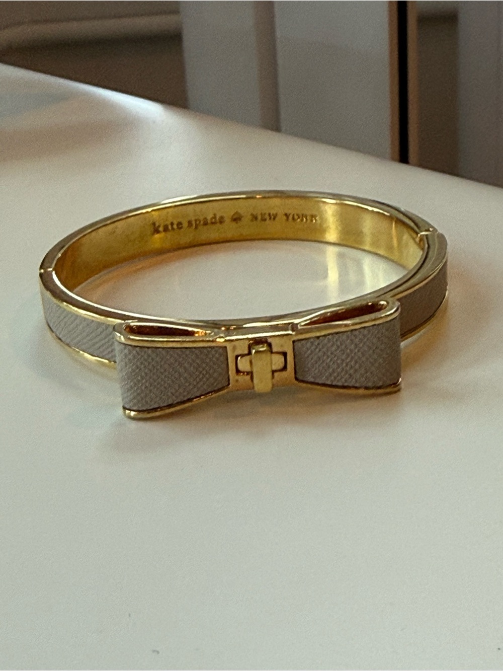 kate spade Gold-tone Bracelet with White textured Bow Accent